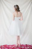 This lace-trim, a-line dress is an elegant option for both brides and bridesmaids. Perfect for summer weddings, the simple gracefulness of The Claire Dress can be worn alone or be coordinated with a delicate capelet.  Adjustable straps  Fully lined with hidden back zipper  Falls approximately 24” from natural waist  Steam or dry clean only  