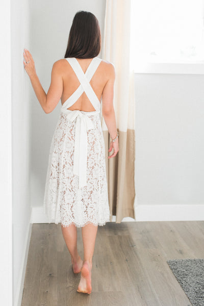 Our Skye Halter Lace Dress is one feminine midi dress!  Designed on a soft floral lace, lined with nude and a low back, this dress is a must-have for your wedding festivities, whether it is a bridal shower, rehearsal dinner, and reception.  Straps designed to wear it multiple ways.    Zip back. Fully lined. Length 40 inches from strap.