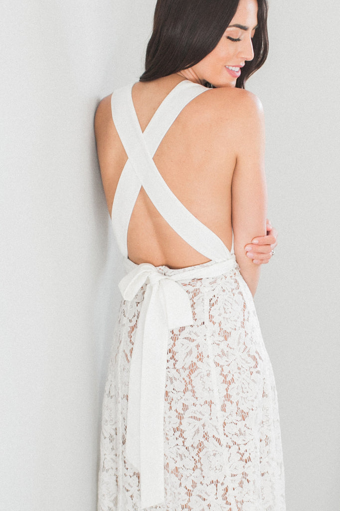 Our Skye Halter Lace Dress is one feminine midi dress!  Designed on a soft floral lace, lined with nude and a low back, this dress is a must-have for your wedding festivities, whether it is a bridal shower, rehearsal dinner, and reception.  Straps designed to wear it multiple ways.    Zip back. Fully lined. Length 40 inches from strap.